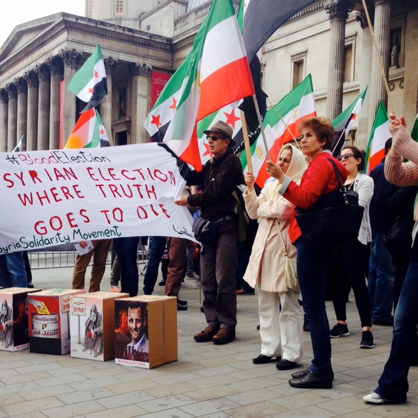 "Why is our blood so cheap" - Syrian at protest against Assad's 'Blood Elections' episode artwork